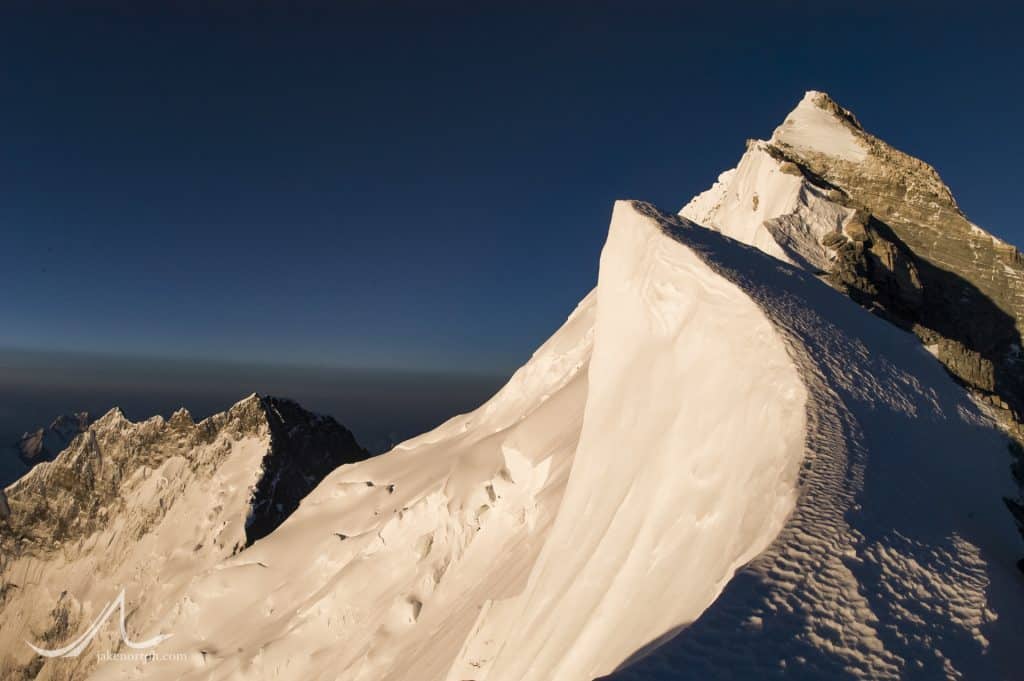 Gazing up the sweeping cornices and rock steps of Mount Everest’s Northeast Ridge from Mushroom Rock at 28,300 feet. Lhotse rises behind and left.