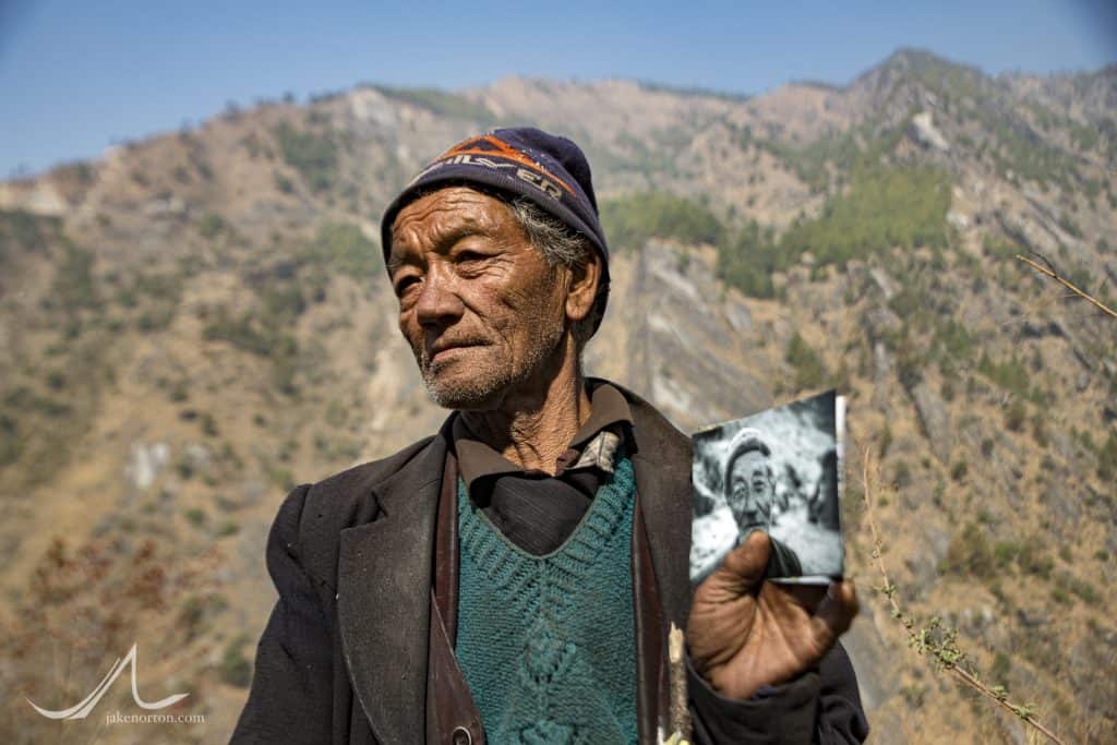 Baje, or Grandather, in Syabru Besi, Nepal, holding a photo from Jake Norton taken the year before - like the only photo of himself he's ever had.