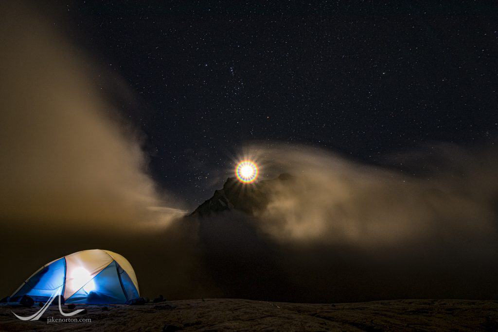 A nearly-full moon rises over Mount Tutoko - the highest peak in the Darran Mountains - as viewed from Turner's Bivvy on the shoulder of Mt. Madeline, Fiordland National Park, New Zealand.