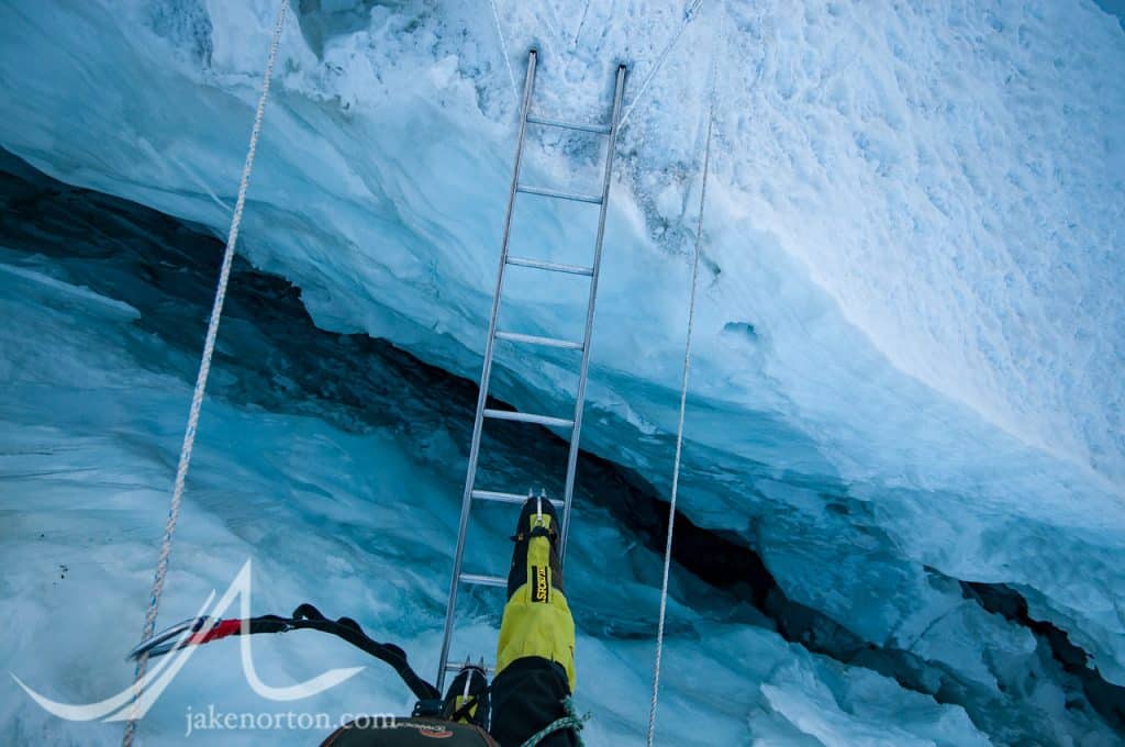 Crossing a crevasse in the Khumbu Icefall, Mount Everest, Nepal.