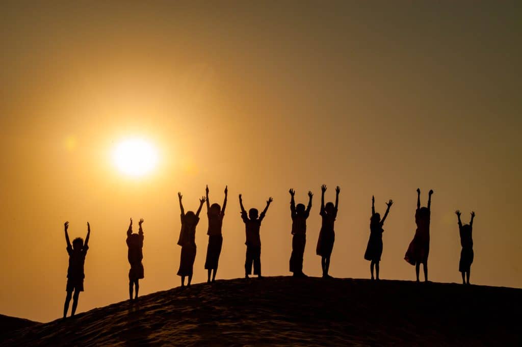 Children celebrating in the dunes of the Great Thar Desert outside of Manvar, Rajasthan, India.
