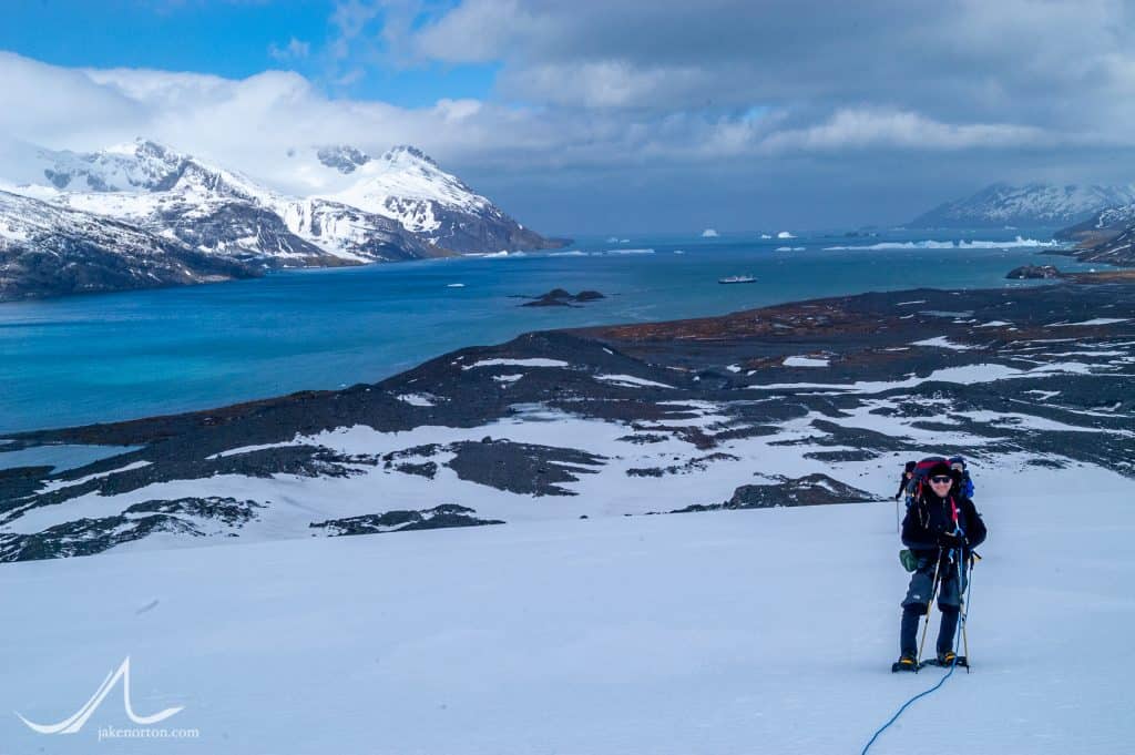 Climbers pick their way up the Murray Snowfield on South Georgia. King Haakon Bay and the beach at “Peggotty Camp” are visible behind, as is the MS Endeavour.