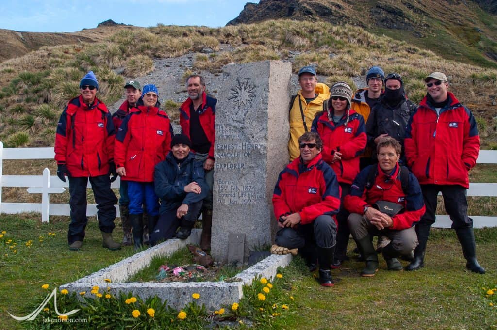 The 2004 Shackleton Crossing team poses at the grave of Sir Ernest Shackleton in Grytviken.