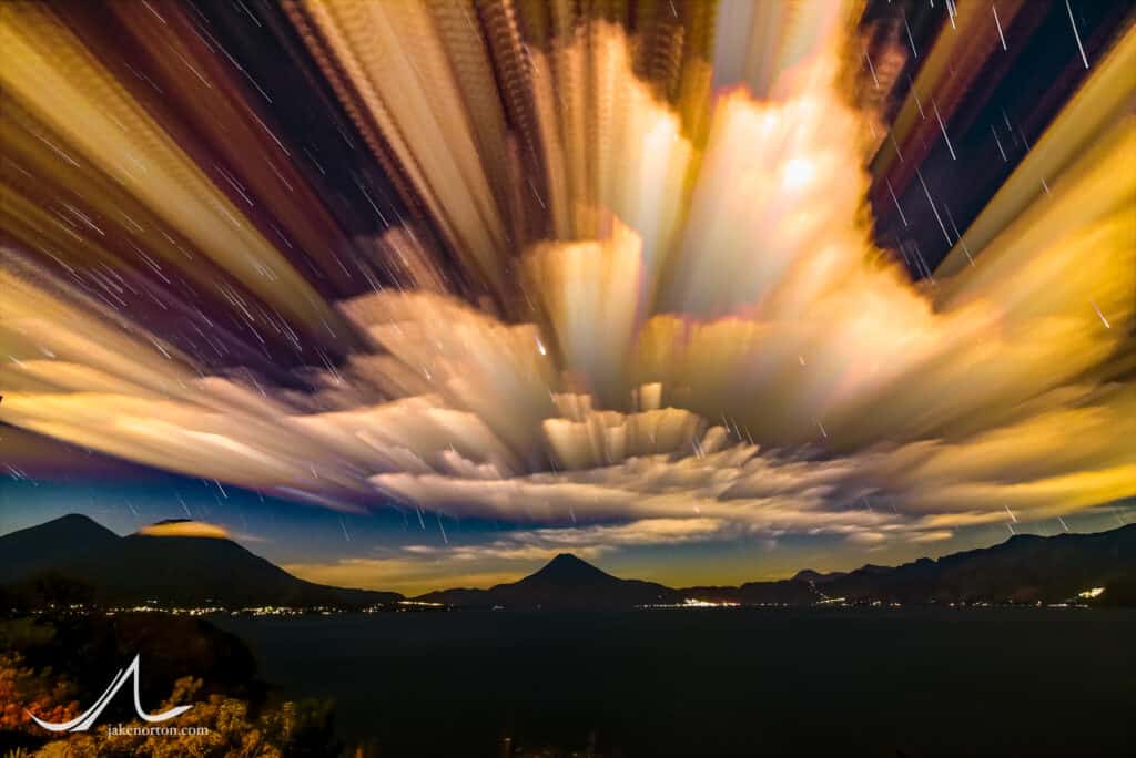 Sunset over Lake Atitlán, Guatemala, 2016. This image is from a timelapse of 1800+ images taken over five hours, time-stacked and re-rendered to show the accumulation of clouds and stars over the entire duration.