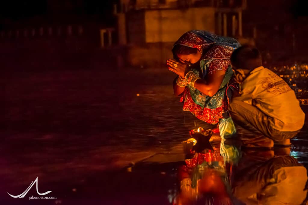 A woman and her son pray and pay homage to Maa Ganga - Mother Ganges - at Triveni Ghat on the banks of the Ganges River in Rishikesh, India.