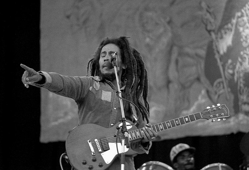 Bob Marley performing at Dalymount Park, on 6 July 1980. Photo by Eddie Mallin, used with permission via the Creative Commons Attribution 2.0 Generic license (https://creativecommons.org/licenses/by/2.0/deed.en) from Wikipedia (https://commons.wikimedia.org/wiki/File:Bob-Marley_3.jpg)