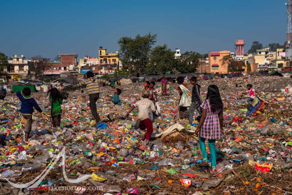 Dalit children run through trash piles outside of Rishikesh, India. Known colloquially as "ragpickers," these children and their families work the refuse of the dump, finding items to be reused, sold, and recycled.