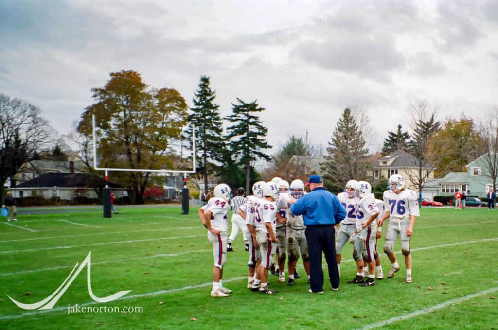 Holderness football coach Norm Walker speaks to the team during the 1992 championship game against Thayer Academy.