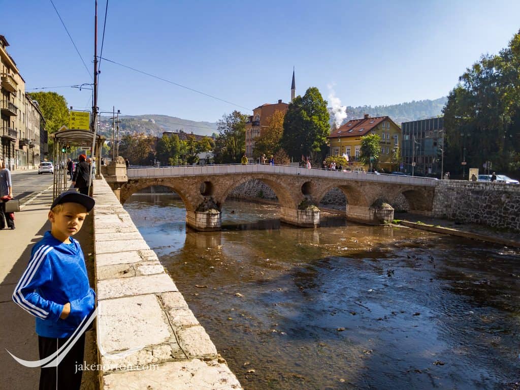 A younger Ryrie in 2019 near the Latin Bridge and the spot where Gavrilo Pricip assassinated Archduke Franz Ferdinand and his wife, Sophie, effectively starting World War I.